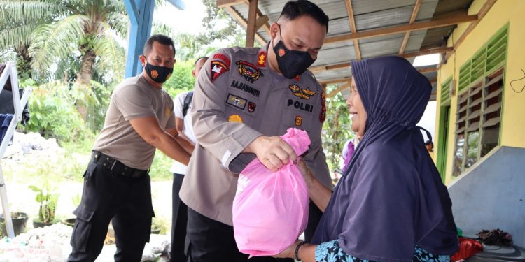 Kapolres Labuhanbatu AKBP Anhar Arlia Rangkuti SIK saat menyerahkan bantuan sembako kepada salahseorang warga