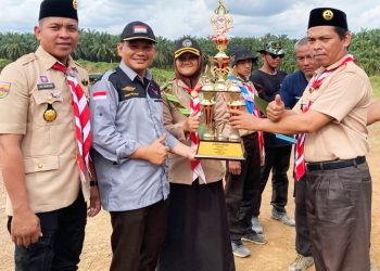 Kamabigus Akhmad Syiroj saat menerima Piala Juara Umum dari Pimpinan Ponpes Darus Sholihin, Ustadz Tholib.