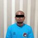 Tersangka saat berada di kantor Polisi.
