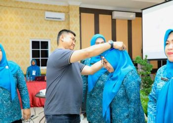 Bupati Labura, Hendriyanto Sitorus, menyematkan tanda peserta saat acara penguatan kapasitas TP. PKK di lingkungan Pemkab Labura 