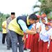 Bupati Labura, Hendriyanto Sitorus, menyapa anak sekolah yang menyambutnya dalam kegiatan Bung Desa ke 18 di Desa Bangun Rejo.