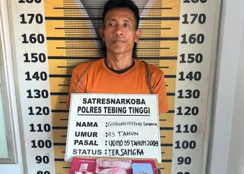 Tersangka saat di kantor polisi.