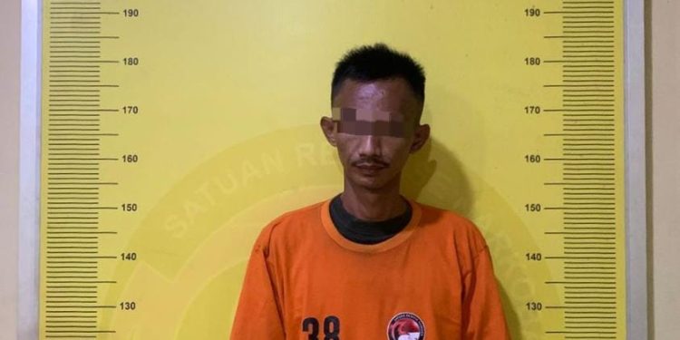 Tersangka saat di kantor polisi.