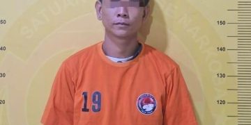 Tersangka saat di kantor polisi.