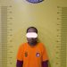 Tersangka saat di kantor polisi.