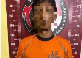 Tersangka saat di kantor polisi.