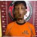 Tersangka saat di kantor polisi.