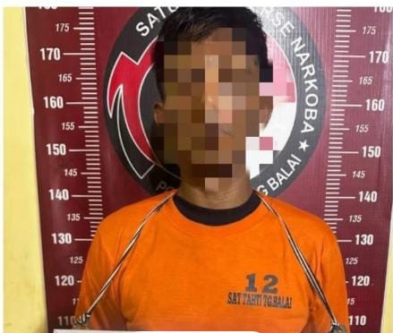 Tersangka saat di kantor polisi.