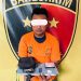 Tersangka saat di kantor polisi.