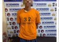 Tersangka saat di kantor polisi.