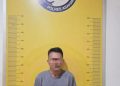 Tersangka saat di kantor polisi.